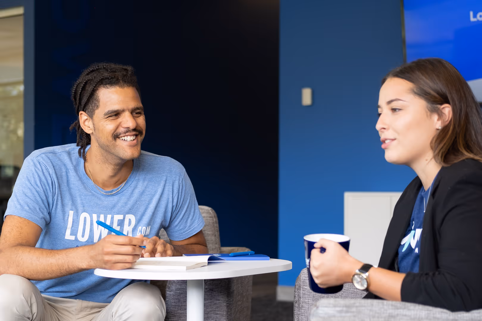 Two Lower.com employees laugh during a meeting