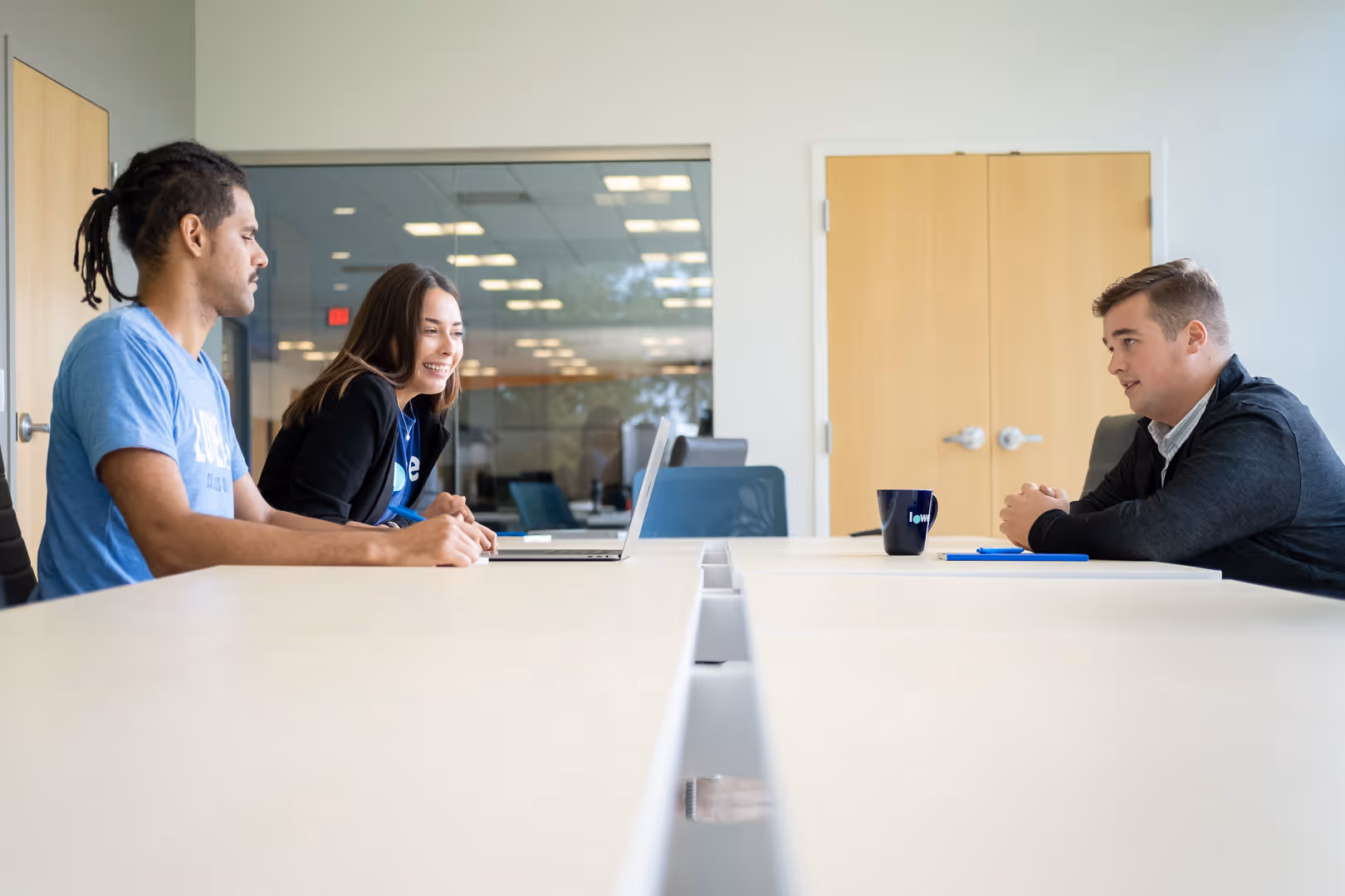 Lower.com teammates meet in a conference room