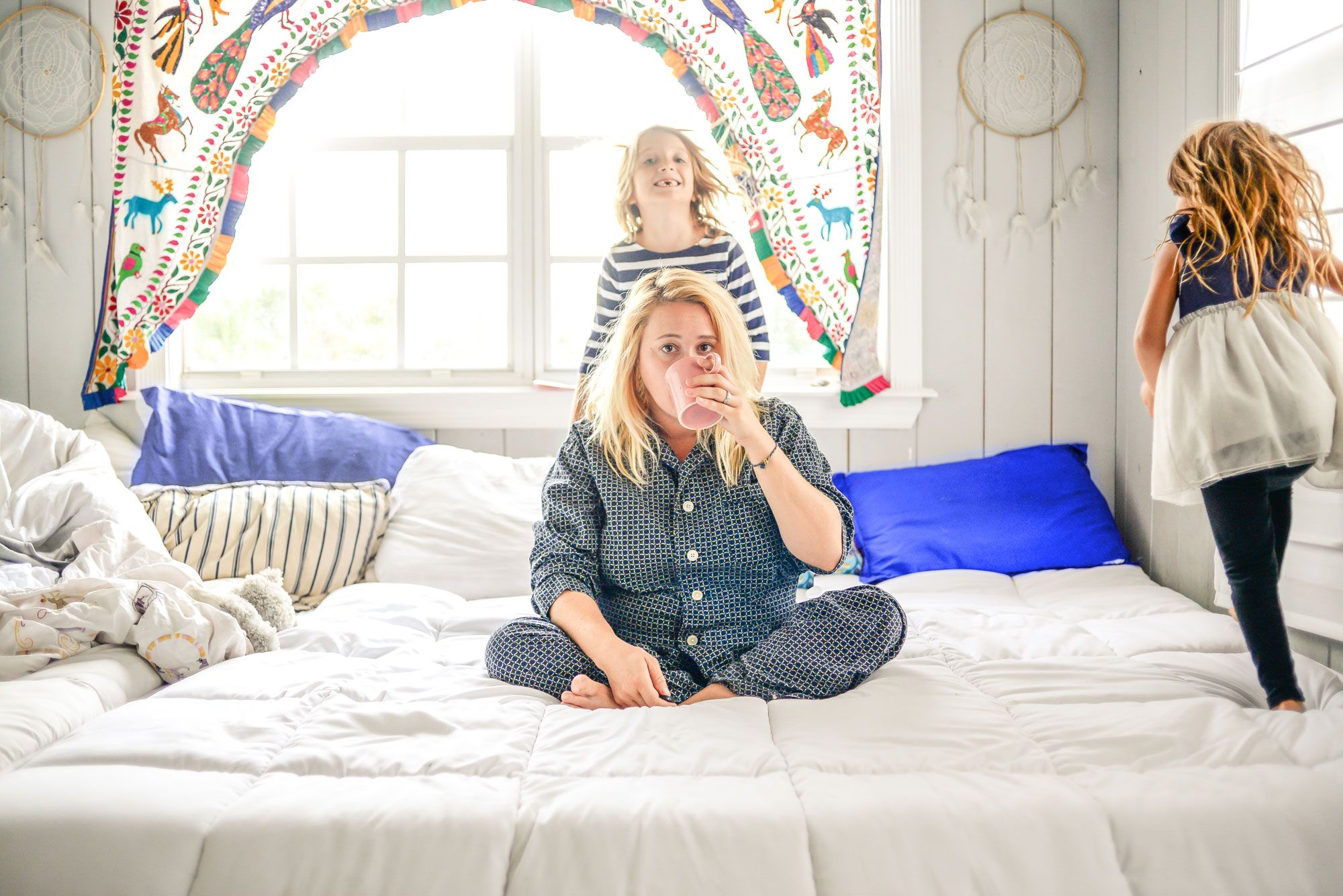 Mom drinking coffee with kids. Is Refinancing with Bad Credit Even Possible?