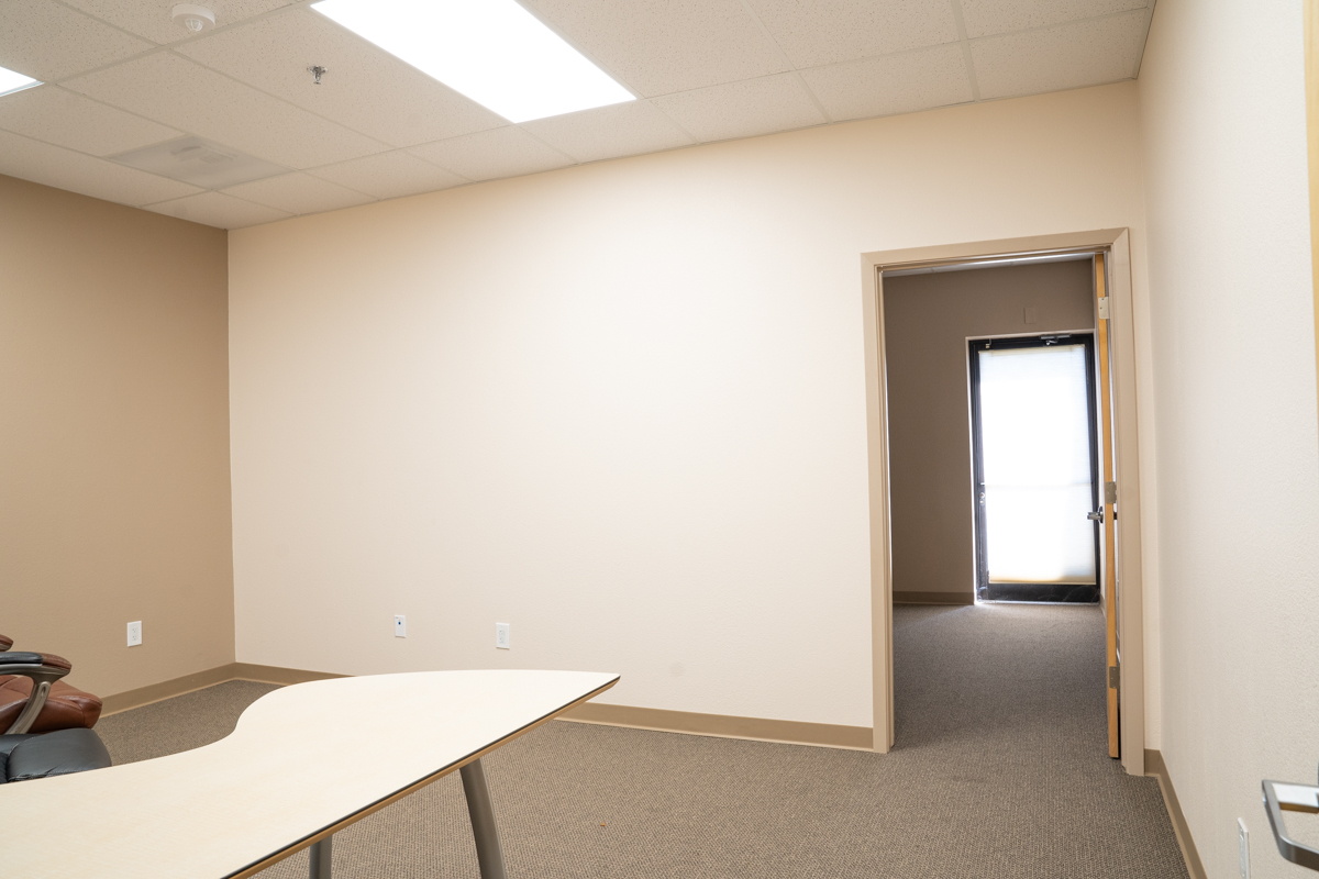 Suite 109 looking in from doorway, desk on the left and back room ahead.