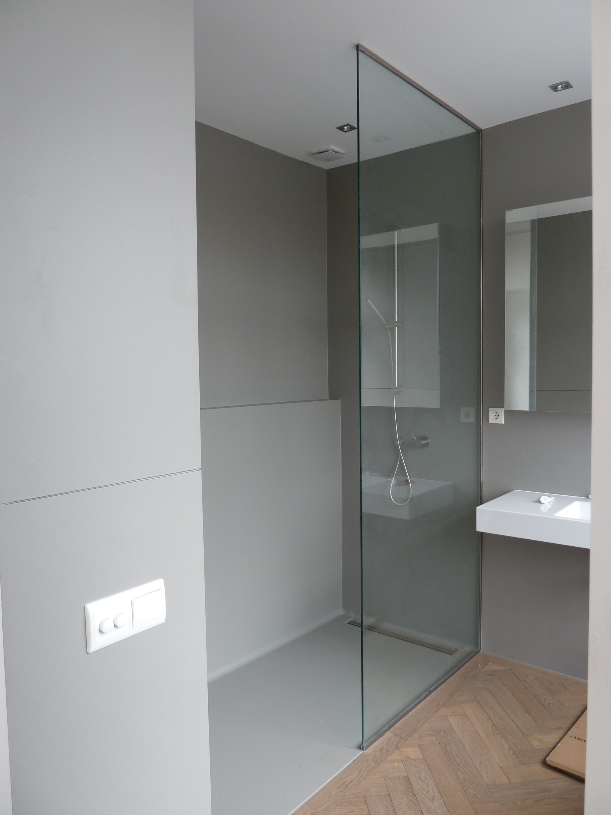 floor-to-ceiling glass shower enclosure