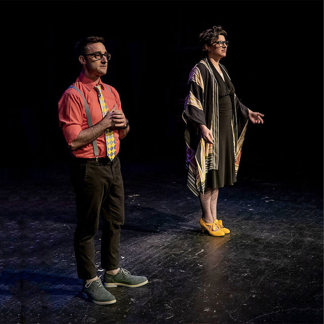 Brian & Annie standing on stage talking to the audience.