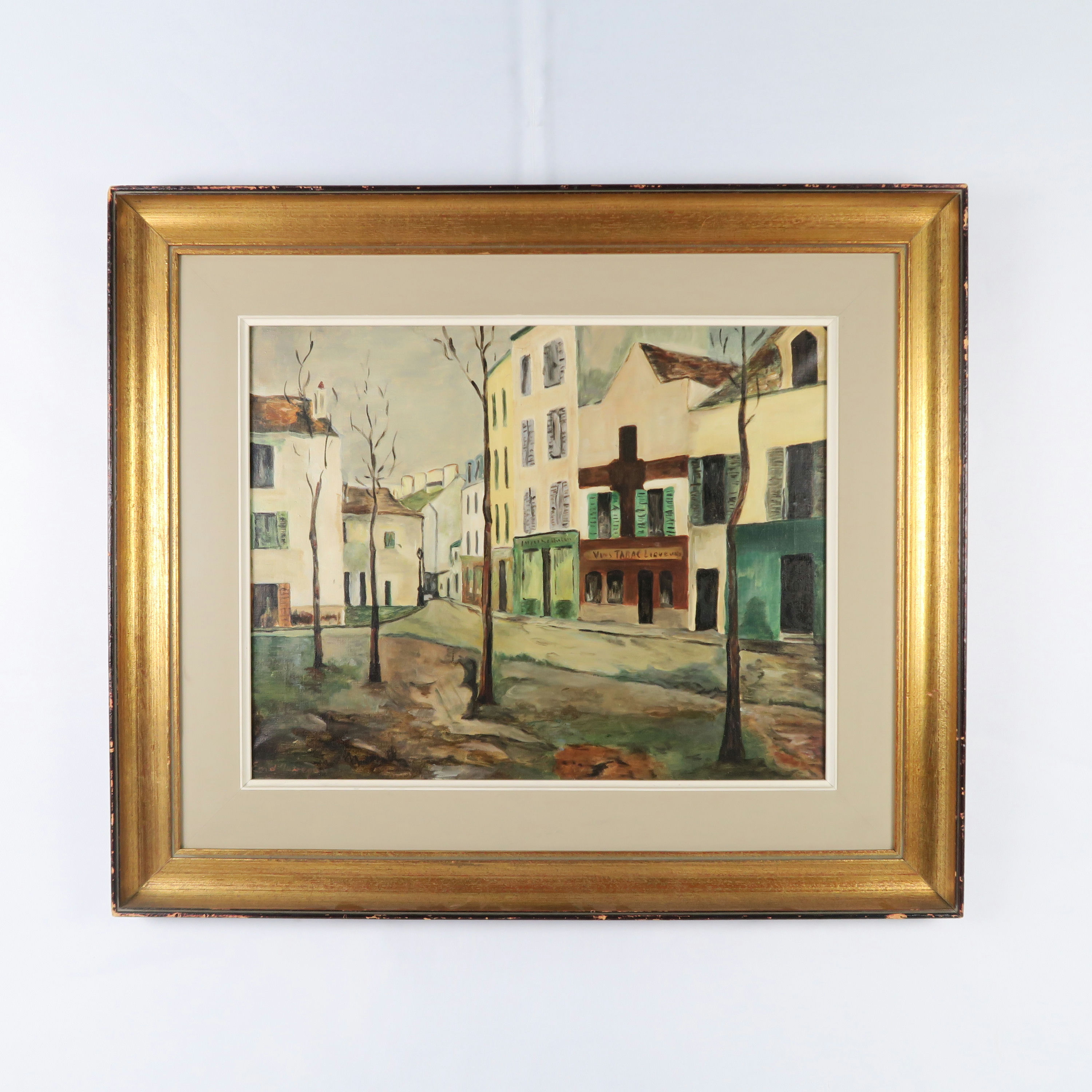 cadre doré et peinture d'un village 