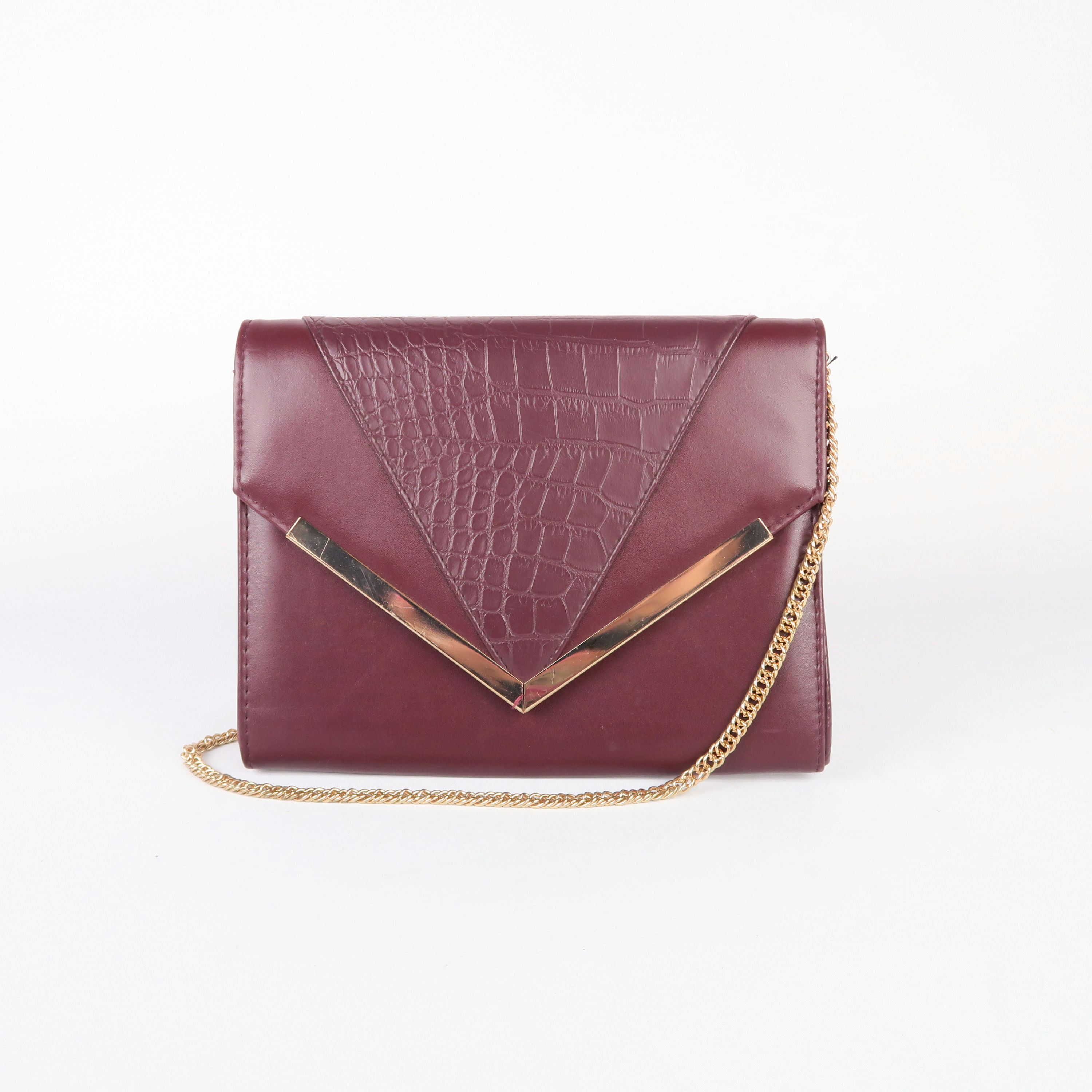 sac à bandoulière bordeau et chaîne dorée