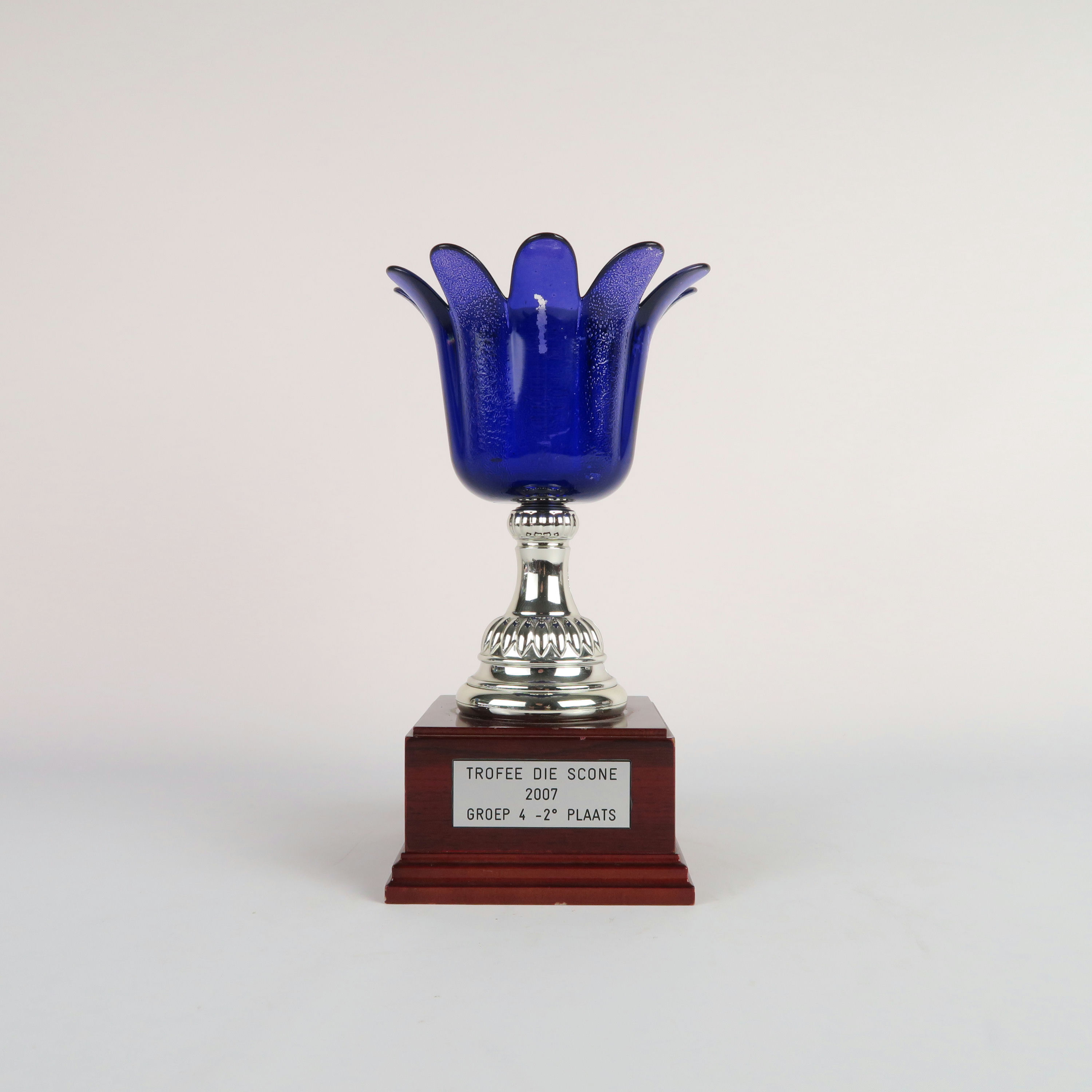coupe bleue et argentée avec son socle en bois