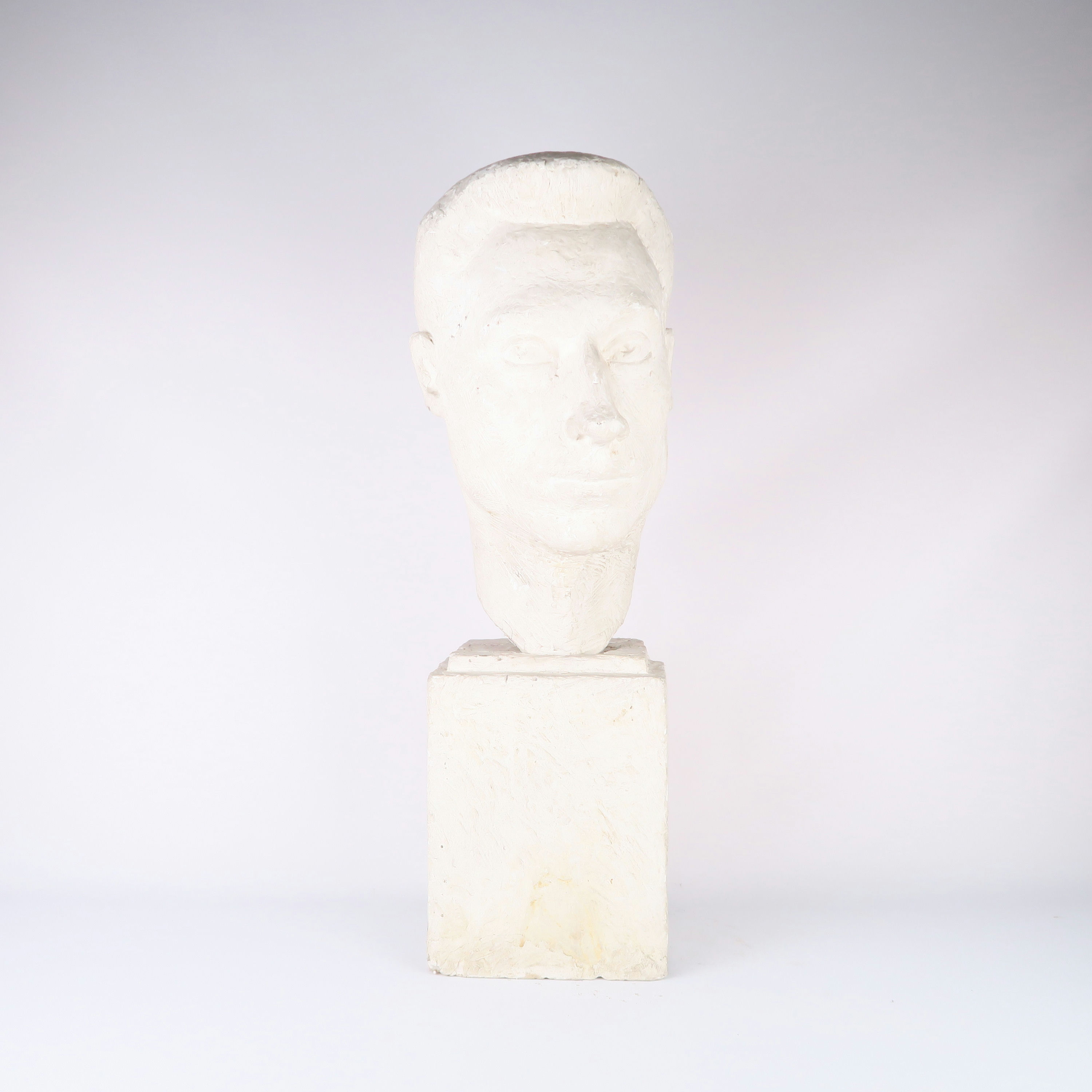 tête d'homme en plâtre sur socle 