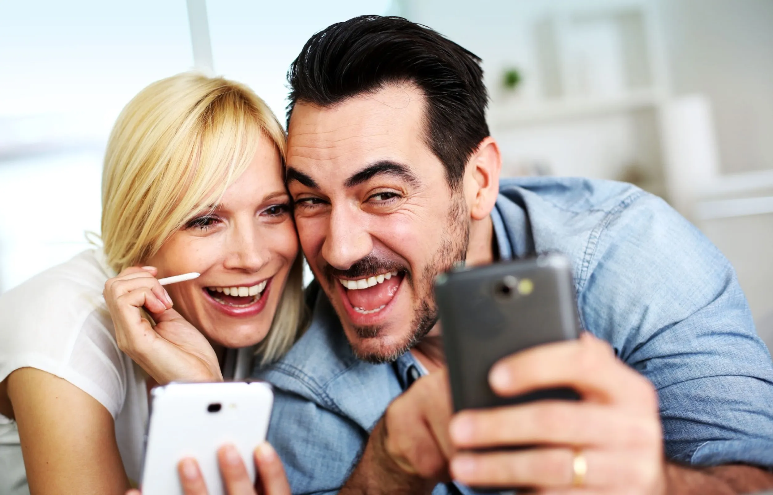 Couple smiling whilst taking a selfie