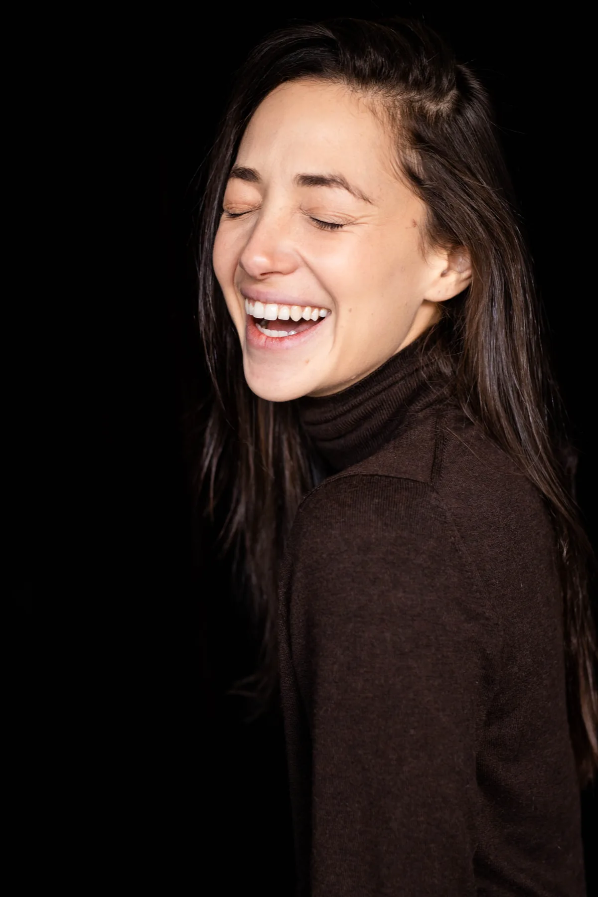 Lee Rubin, Confetti CEO and co-founder, laughing with eyes closed against a black backdrop
