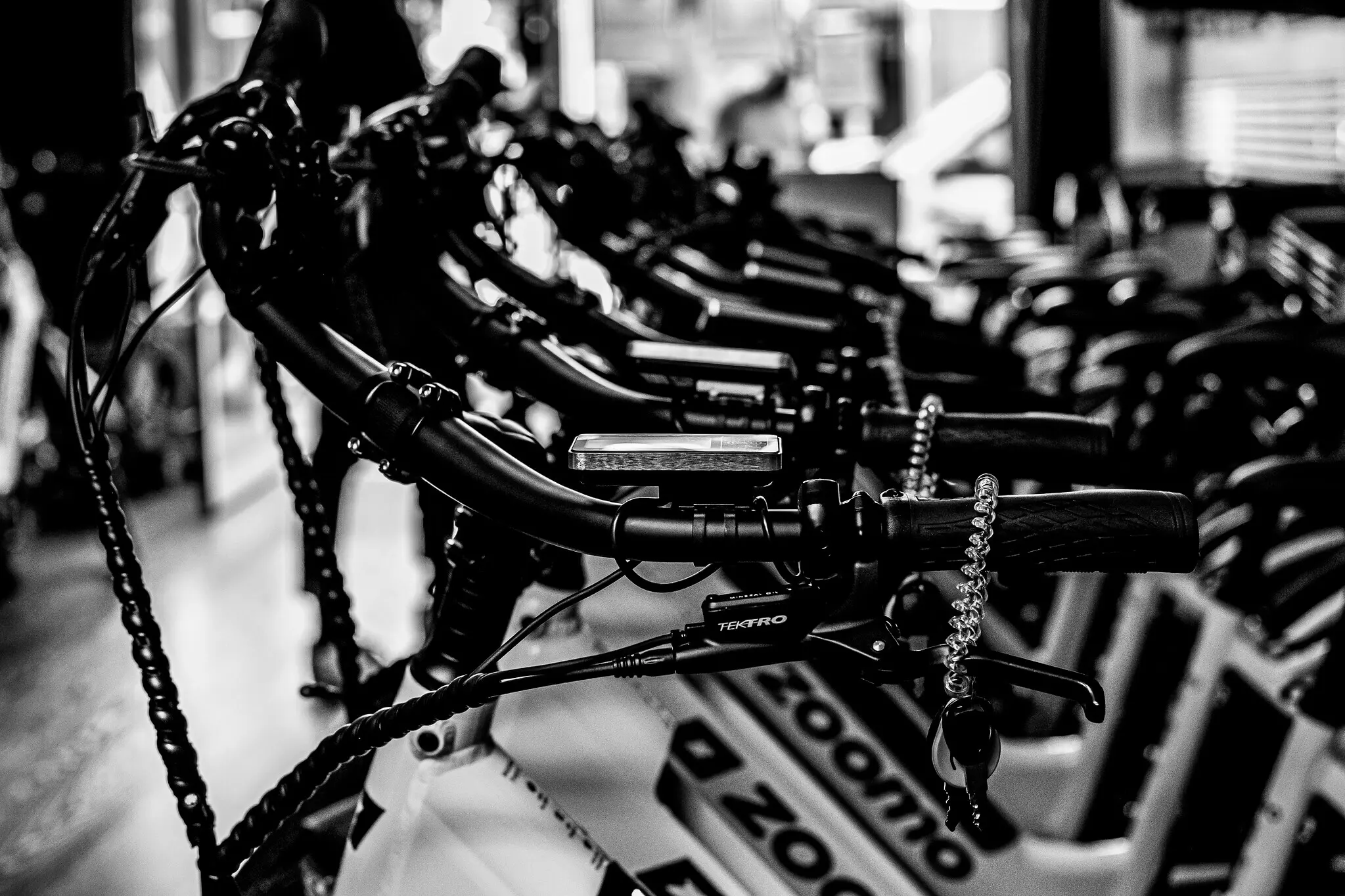 Row of Zoomo delivery e-bikes lined up in the store