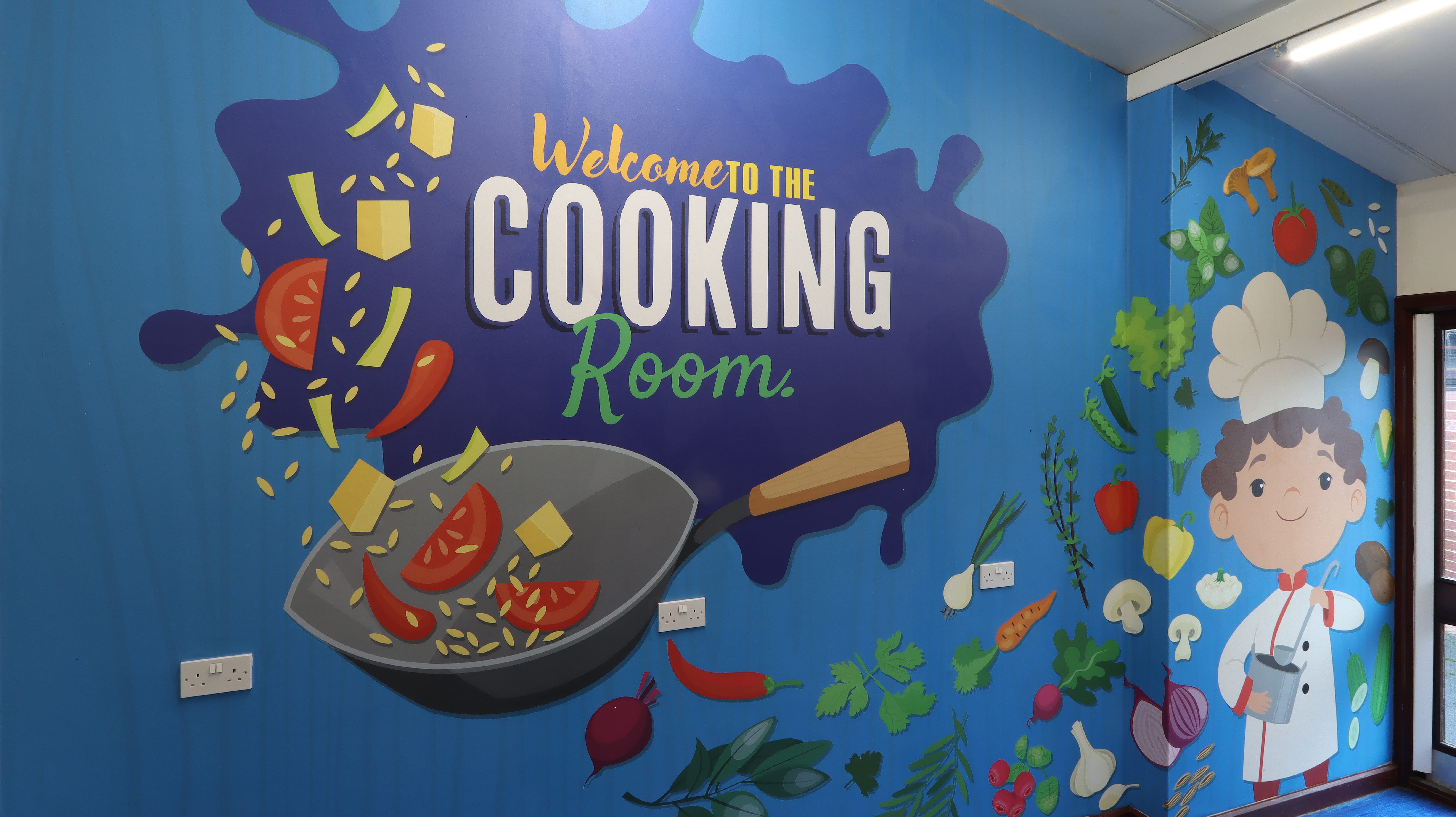 This vibrant wall art at Newcorft Primary Academy brings the world of cooking to life, inspiring a positive attitude toward healthy eating and encouraging creativity in the kitchen. Suitable for cooking rooms and school halls.