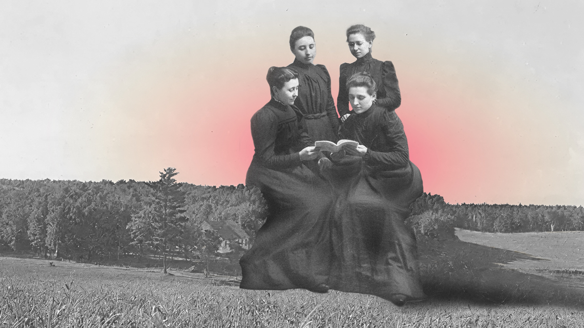 Women reading together, sitting on a forest