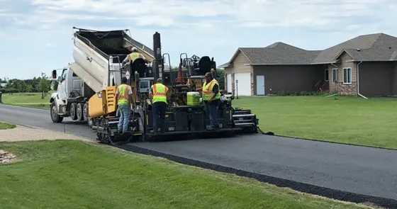 Jensen crew installing asphalt on driveway