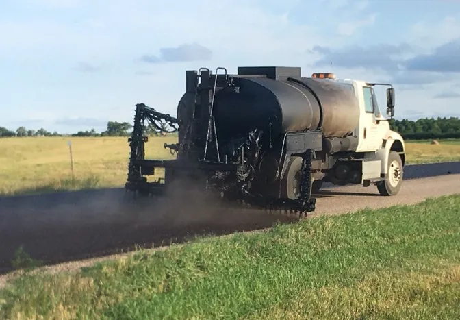 country road being fog sealed