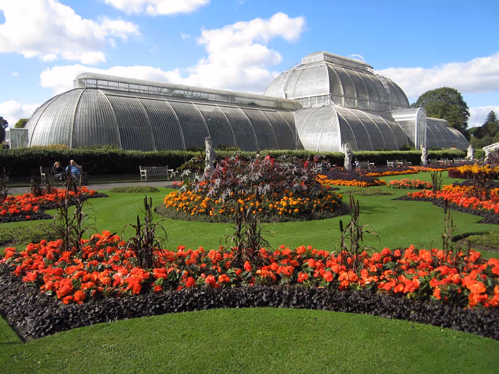 Couple standing on a bridge looking over the water at the Royal Botanic Gardens in Kew.