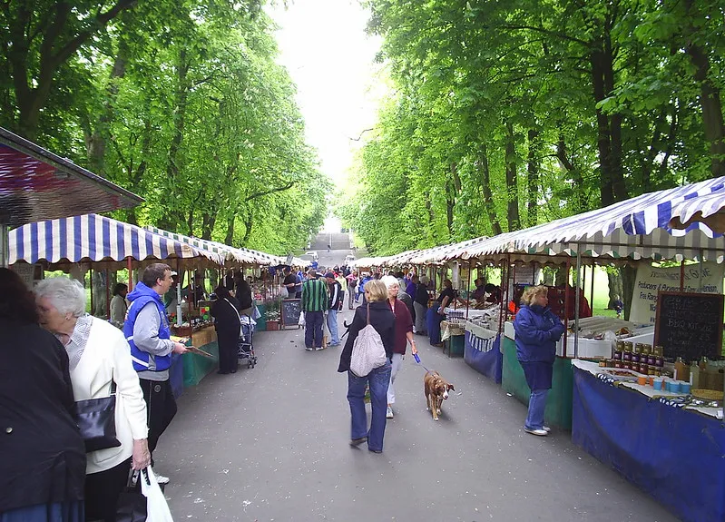 People shopping at Queens Park Farmers' Market in Kilburn.