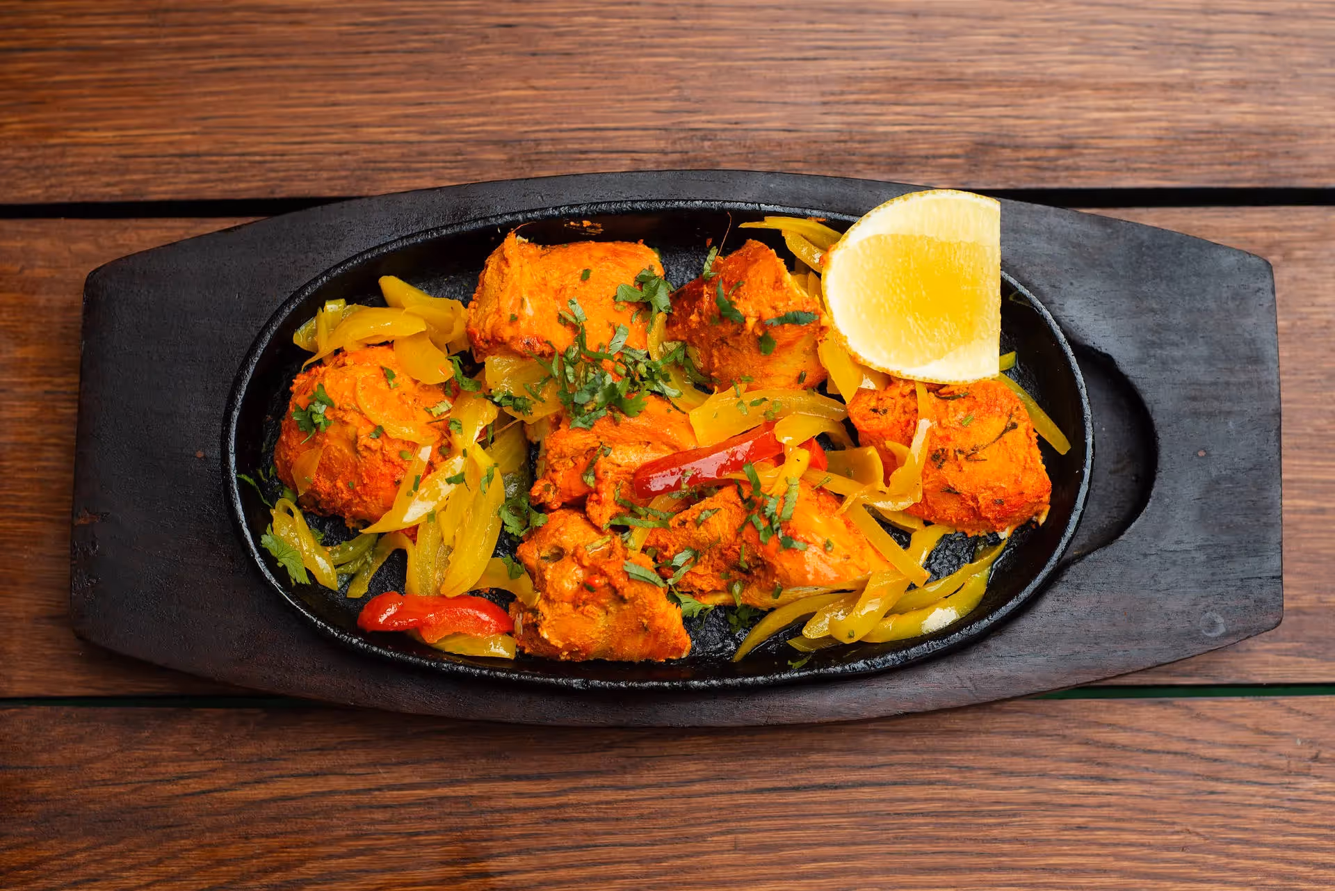 Indian food spread on a wooden table at The Indian Orchid in North Finchley.