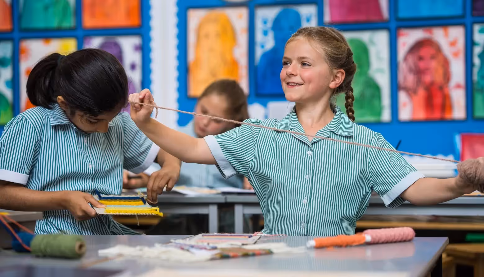 Young girls jumping up and down in the assembly hall at Sarum Hall School in Belsize Park.