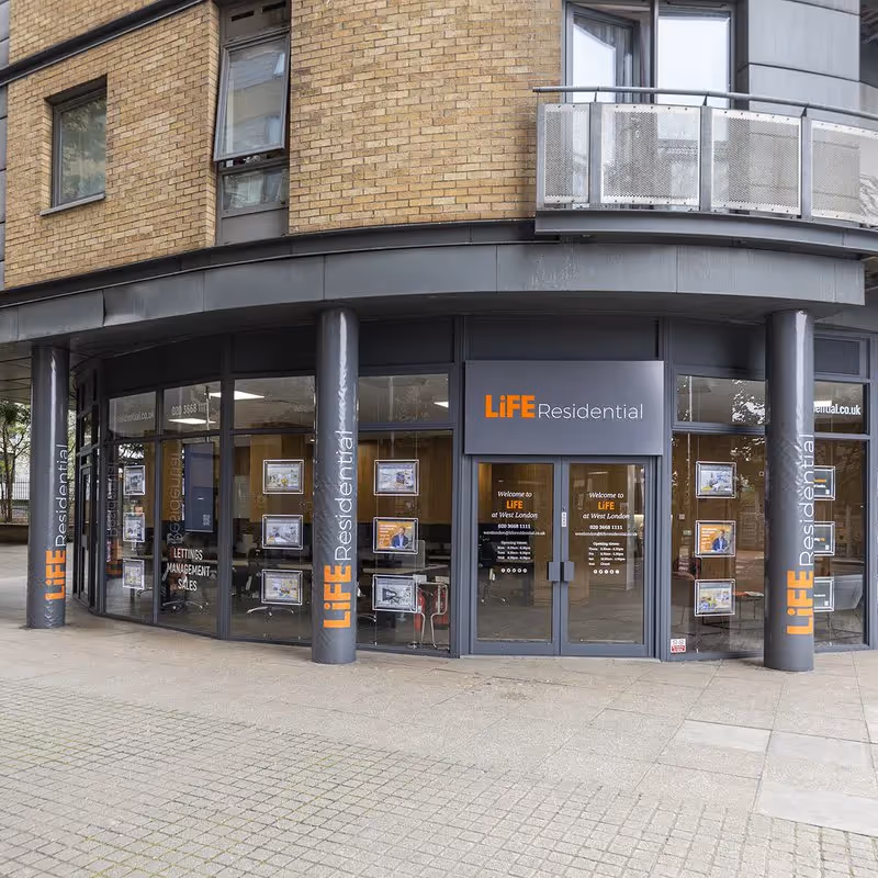 Estate agents working at the desk at LiFE residential in East London.