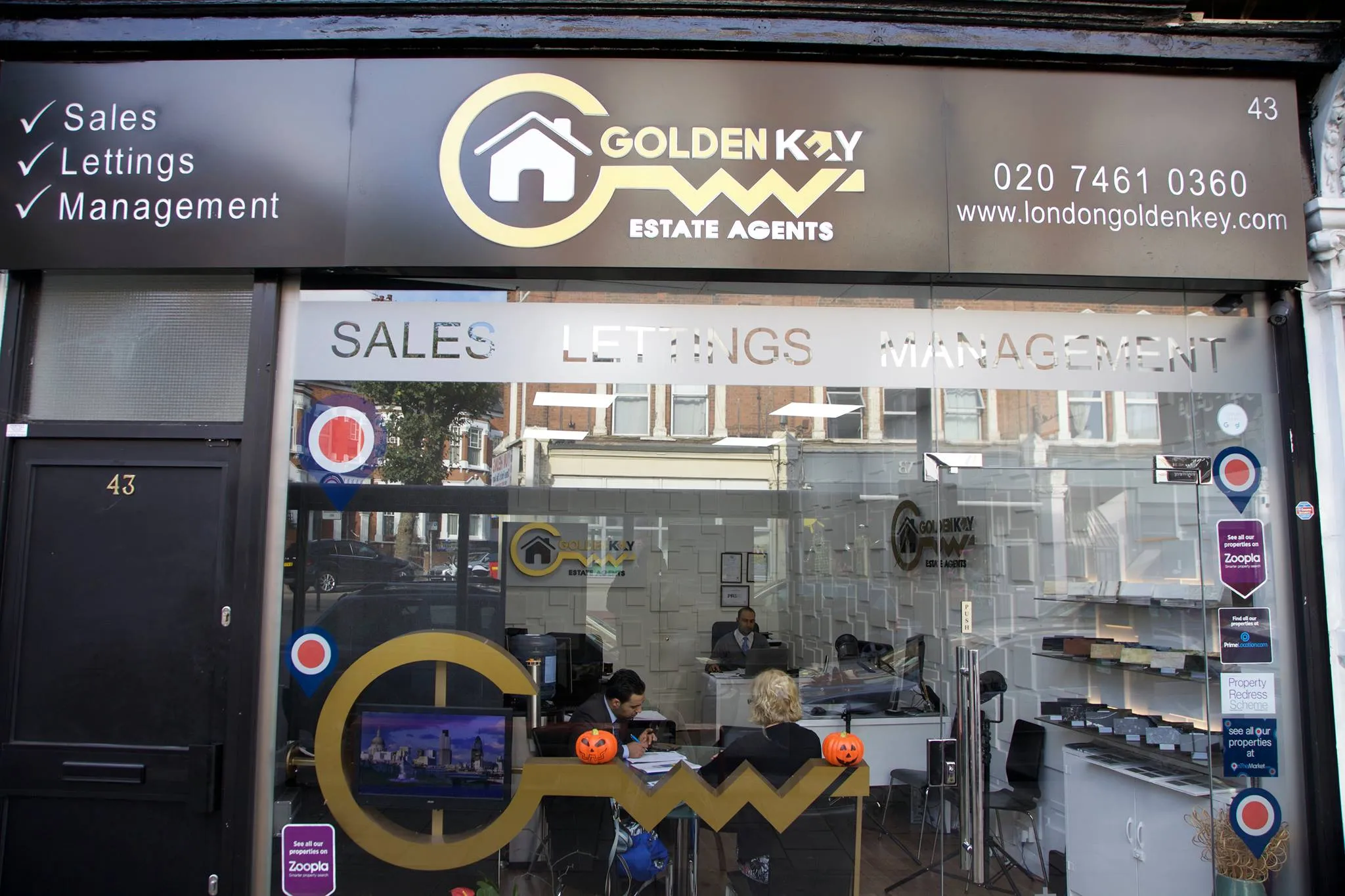 Black shop exterior for Golden Key in Kilburn.