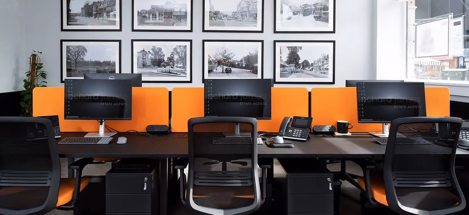Founders Richard and James standing outside their Mill Branch. They are dressed very smartly in suits.