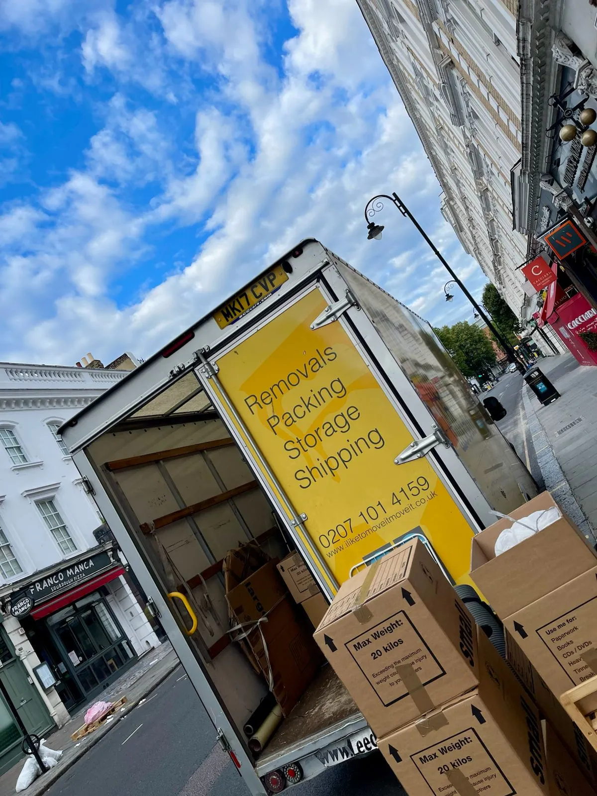 Man and van crew loading boxes into Van on Brompton Road, Kensington SW7