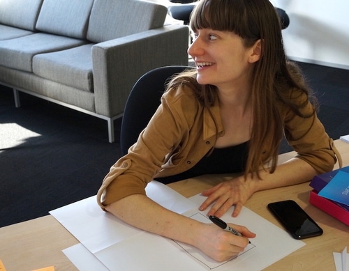 Angela sketching using a sharpie and paper