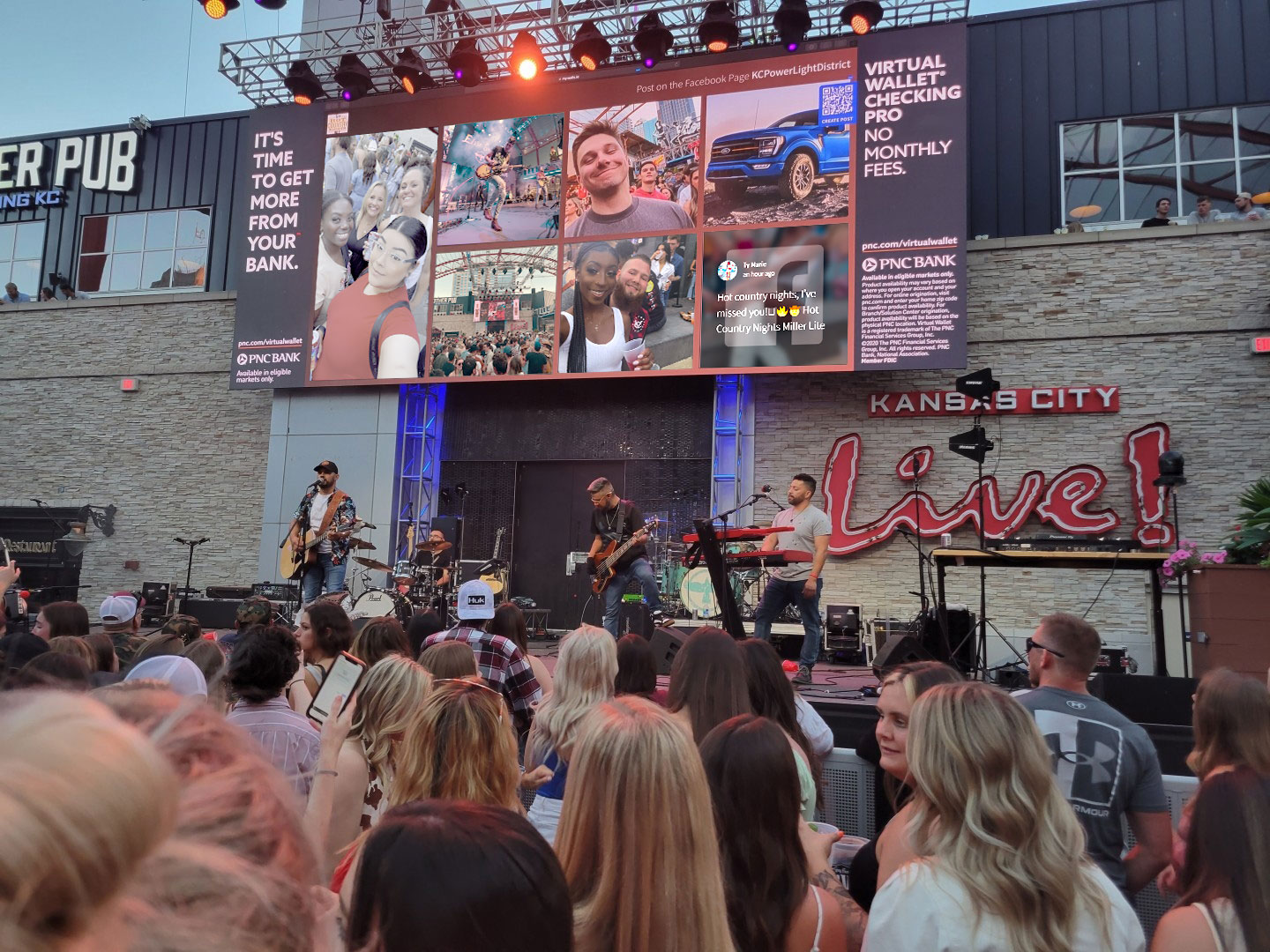 A hashtag wall on a screen at an event displaying photos uploaded by attendees powered by Walls.io