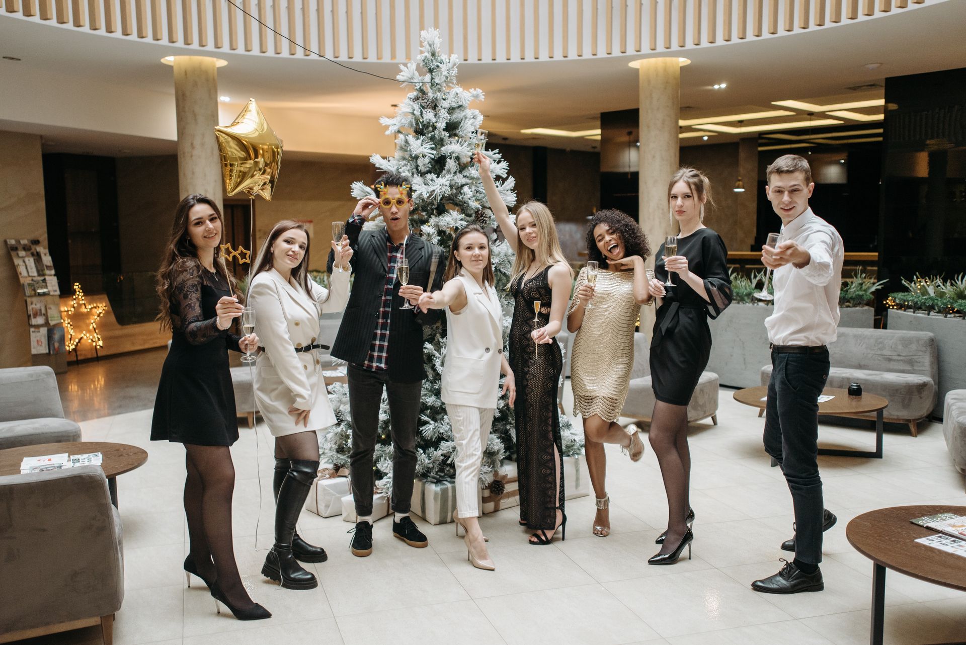 A corporate party planning group posing for a picture together at a holiday get-together