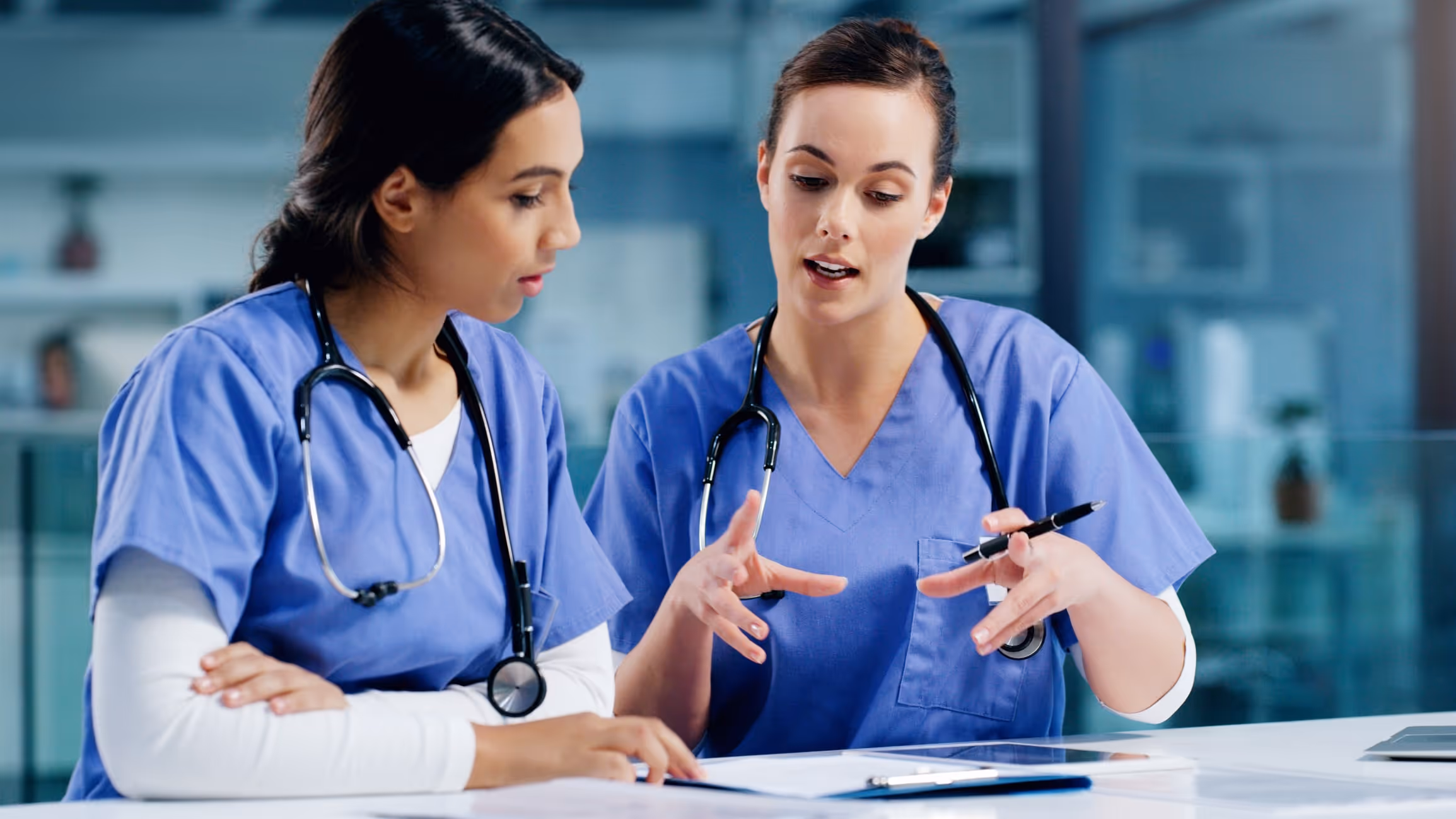 Two nurses collaborating to solve a problem