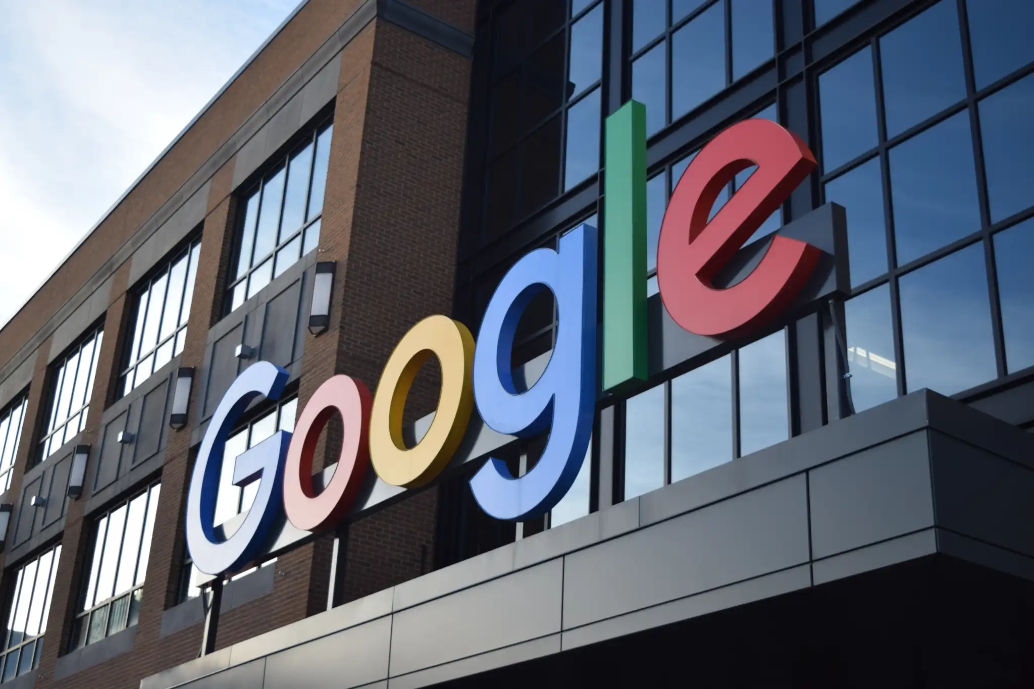 A marquee of a modern office building with the Google logo.