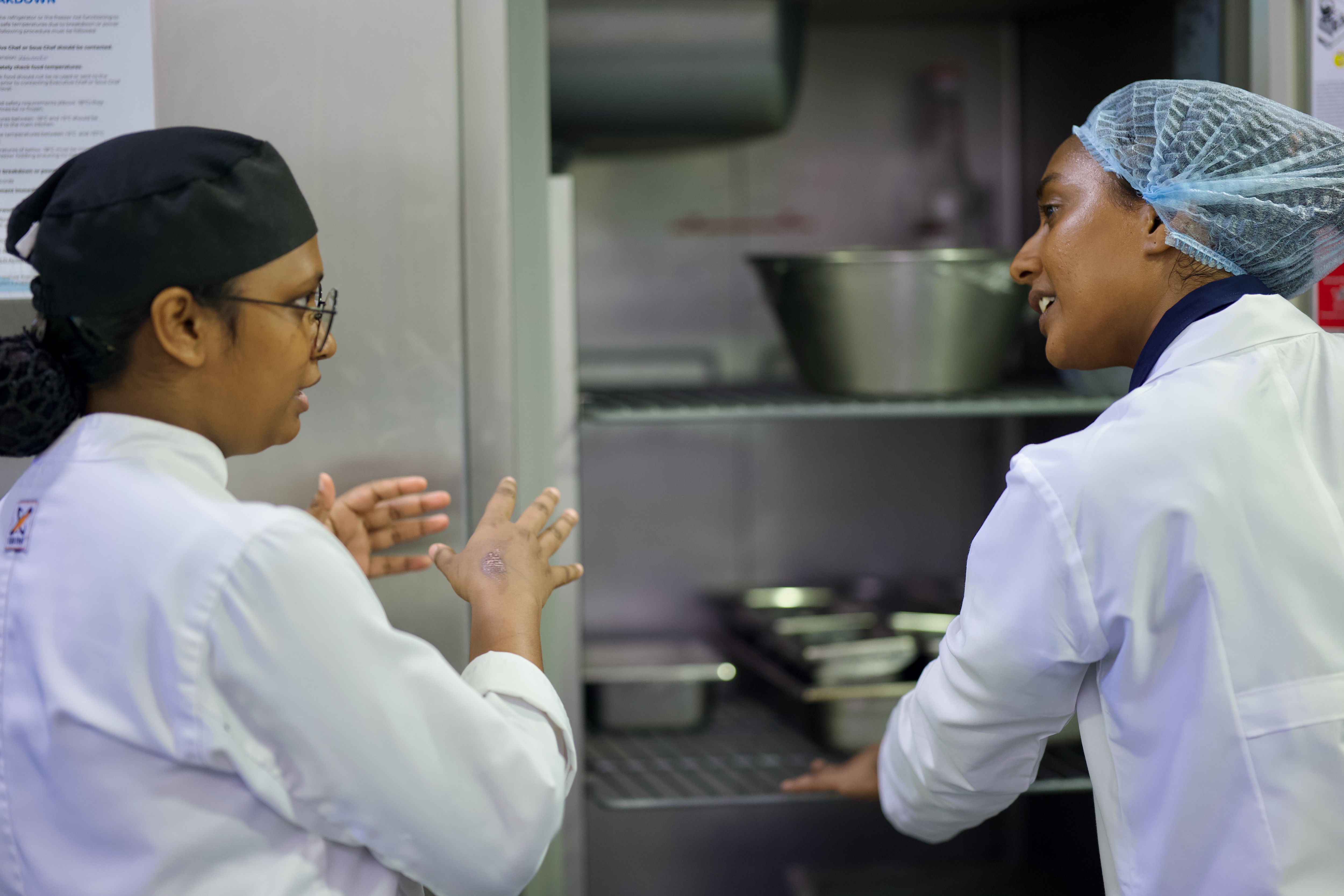Team member Laisa listening to chef talking to them