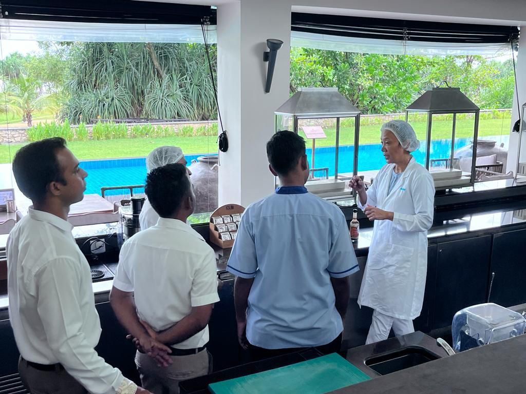 Team member Babli inspecting a bar with resort staff