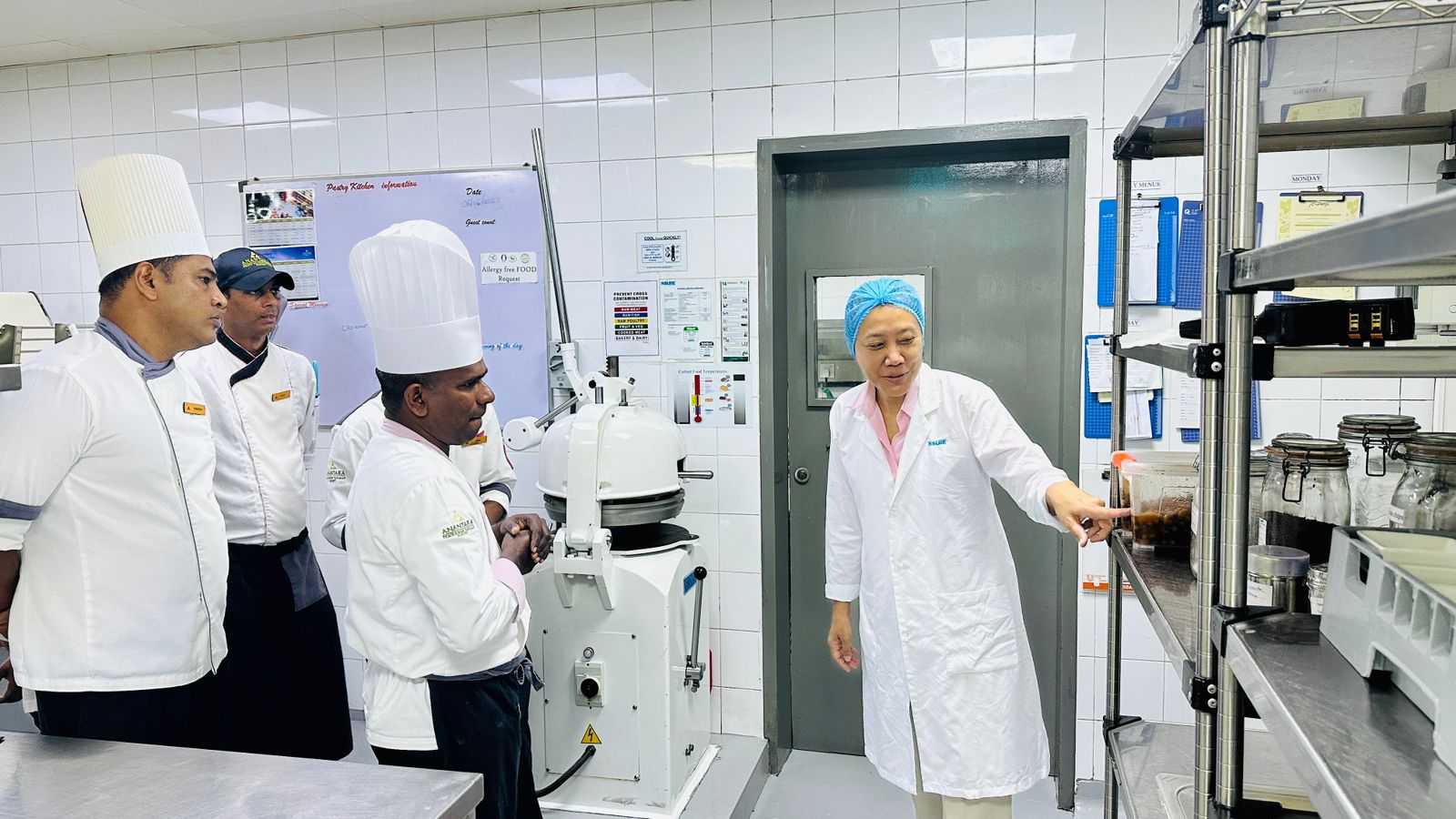 Team member Babli inspecting a kitchen with resort staff