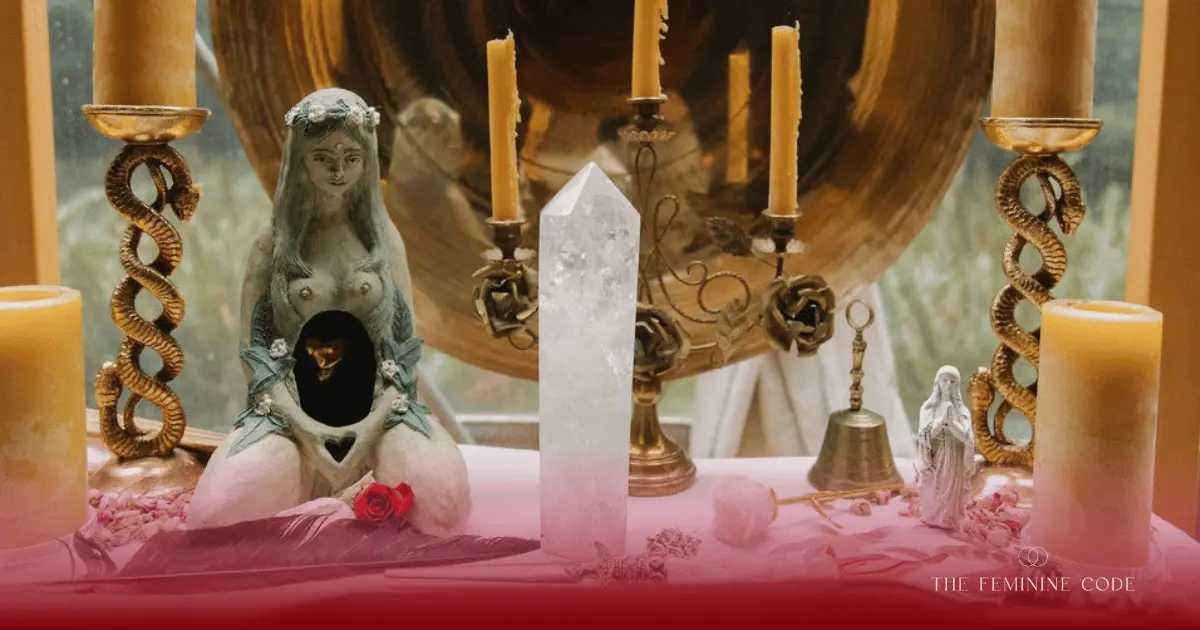 A sacred altar container set with candles and natural elements for a feminine mystery school ceremony.