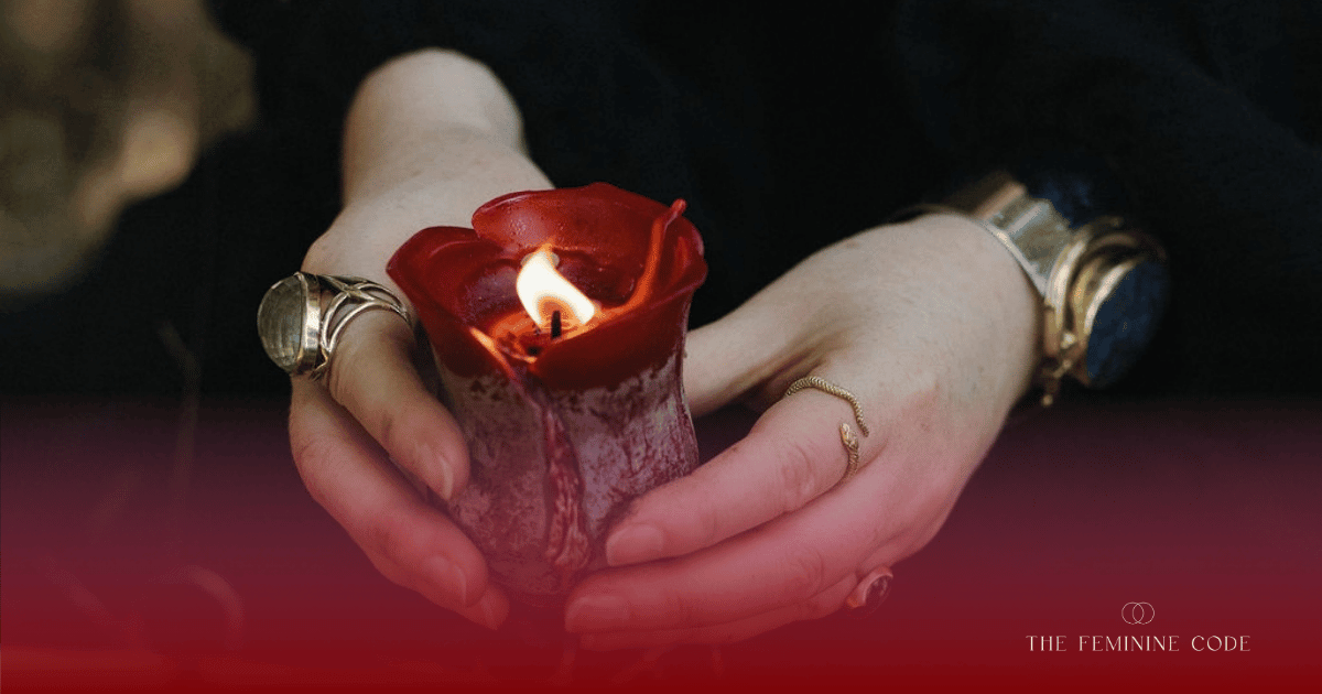 A person dressed in black holding a glowing candle during a sacred Samhain ritual to connect with ancestral wisdom.