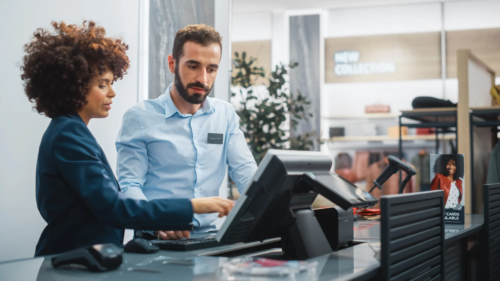 Jewelry store associate texting a customer from the counter of an independent jewelry store