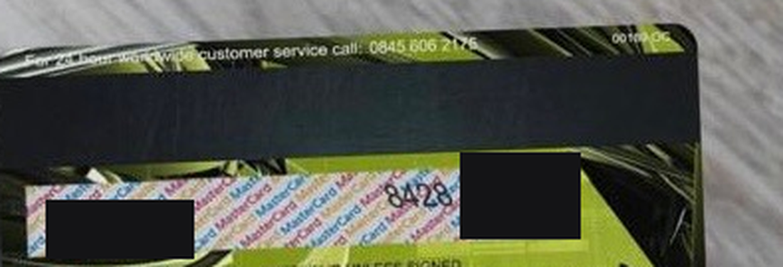 Back of the same fraudulent card showing a UK 0845 customer service number and a repeating Mastercard signature panel, with the security code redacted
