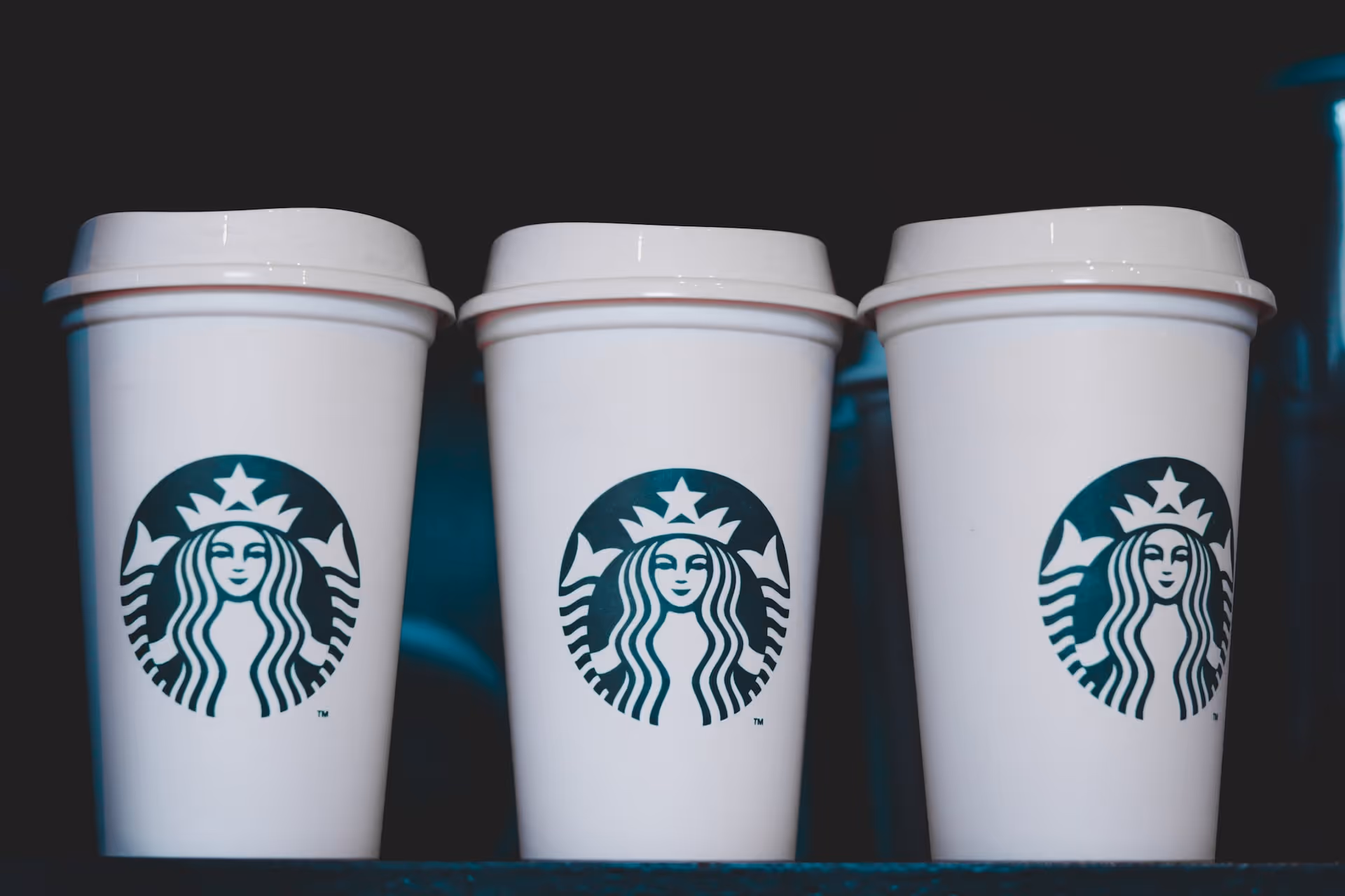 Three Starbucks cups