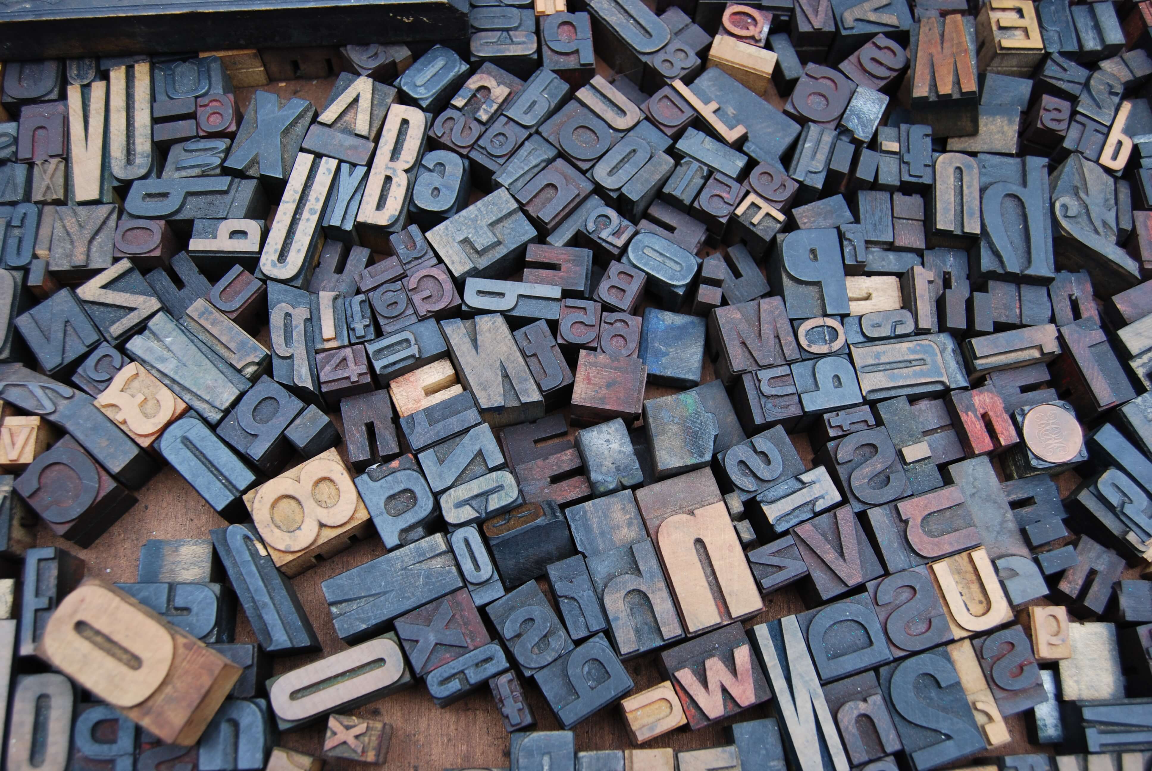 Wooden letters scattered on a desk