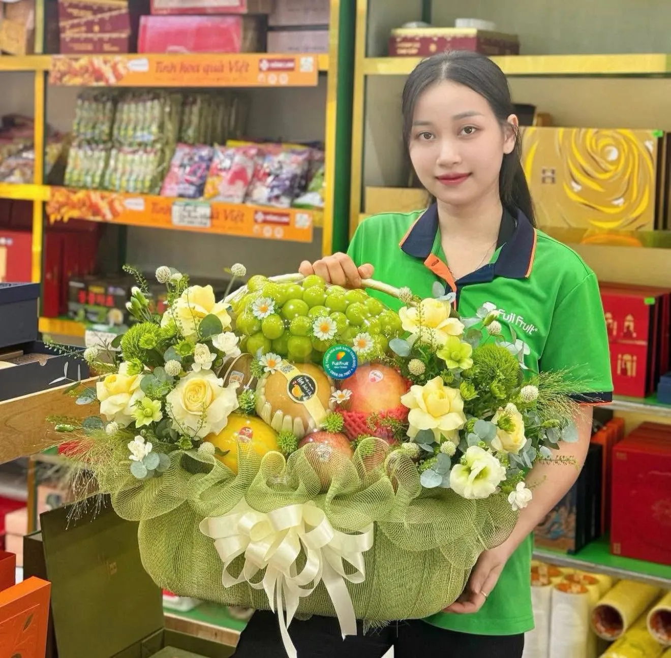 Nhân viên cầm giỏ trái cây trong cửa hàng tạp hóa tại Huyện Nam Đàn, Nghệ An