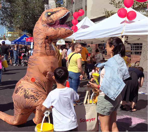 Photo of a dinosaur suit at a Sawyer event