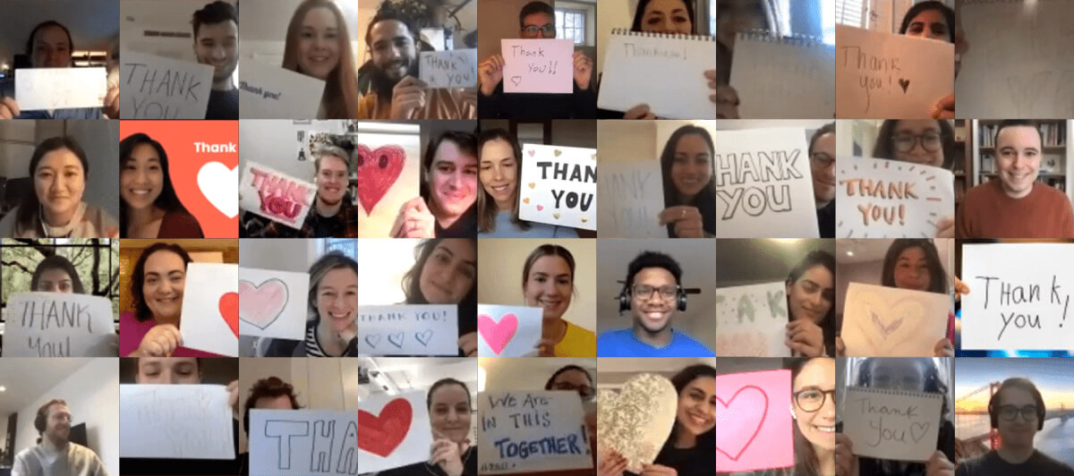 Team holding up thank you signs over Zoom during COVID quarantine