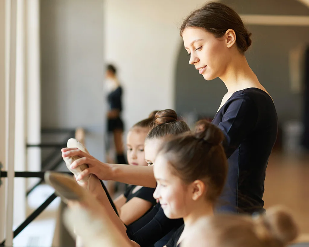 Ballet instructor with class full of students