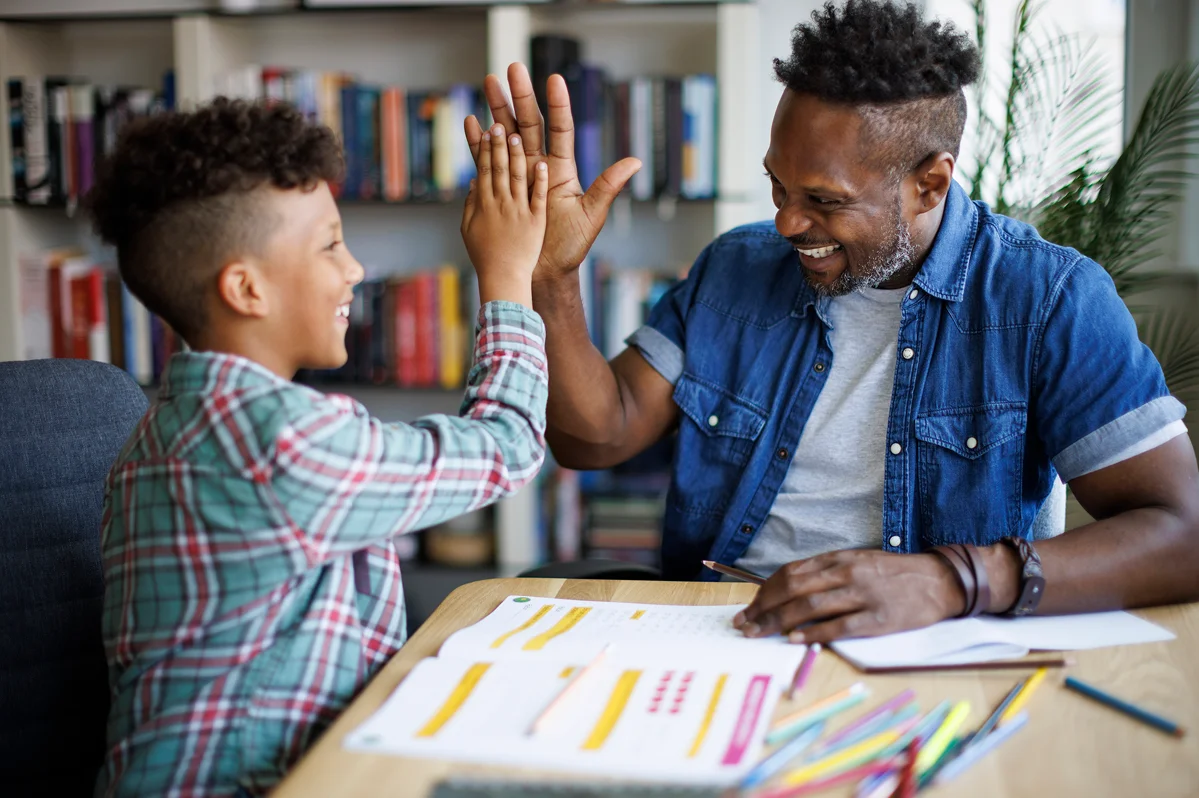 Provider high-fiving a student during a tutoring session
