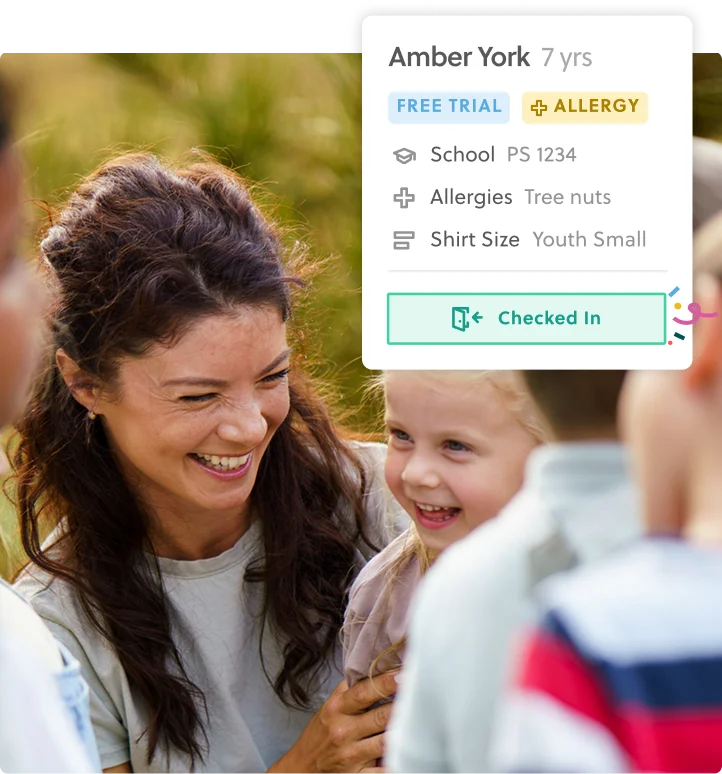 Provider greeting a young girl at camp with profile and check in UI showing