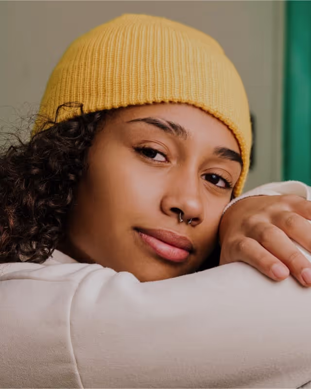 Teenage girl with her head resting on her folded arms