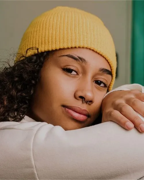 Teenage girl with her head resting on her folded arms