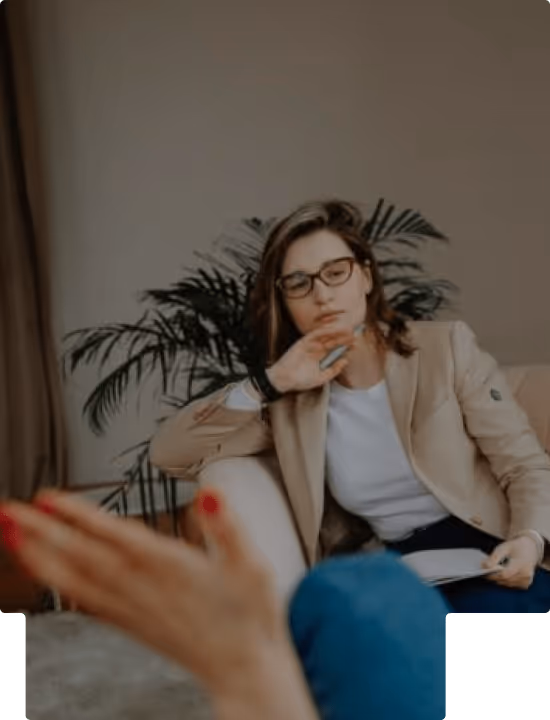 Therapist attentively listening to a patient during a counseling session in a cozy office.