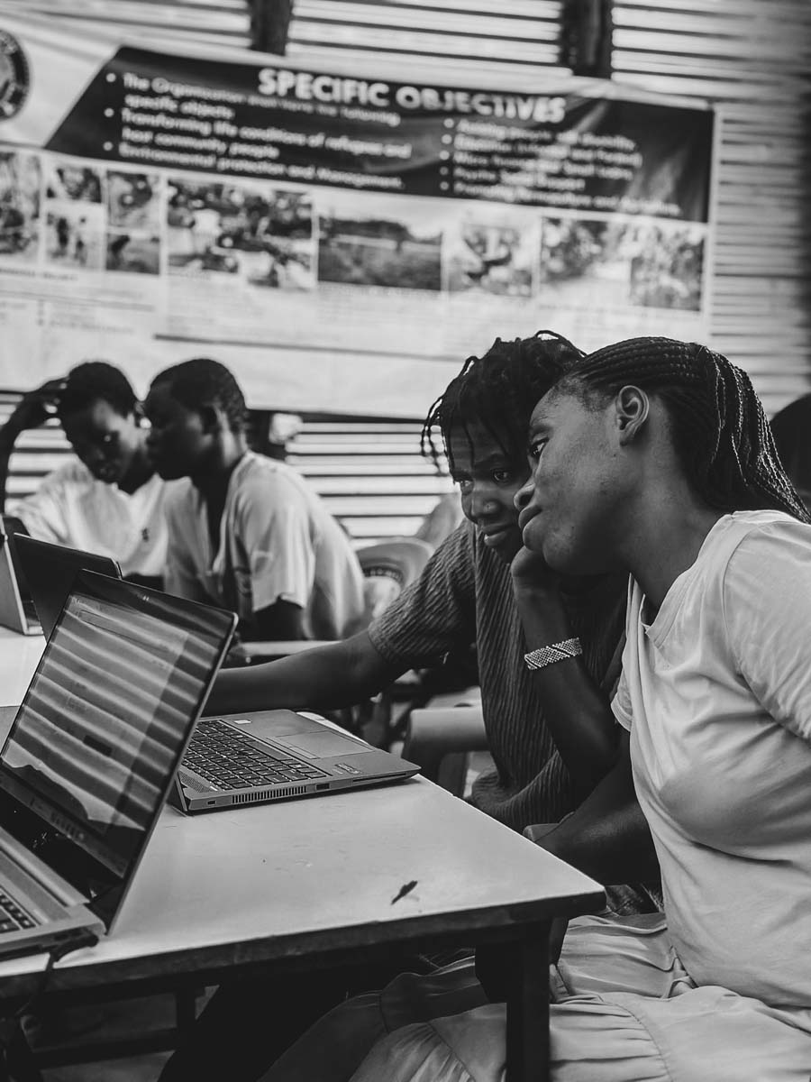 Young people working on laptops, in black and white