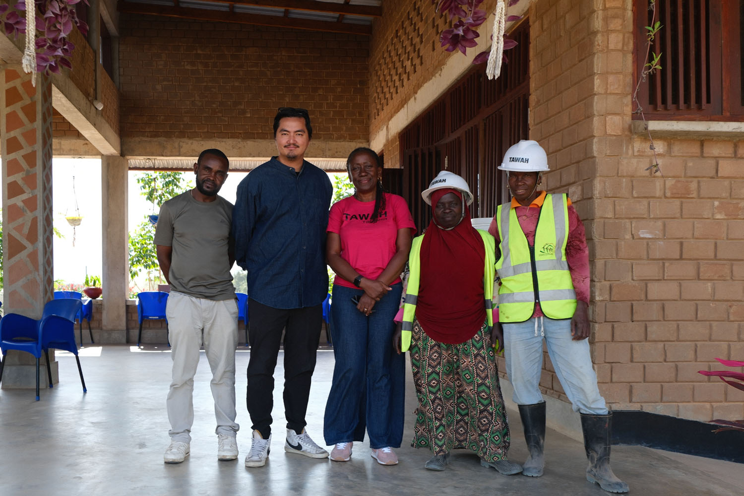 Gody, Jun, Victoria and two TAWAH builders standing together on the campus